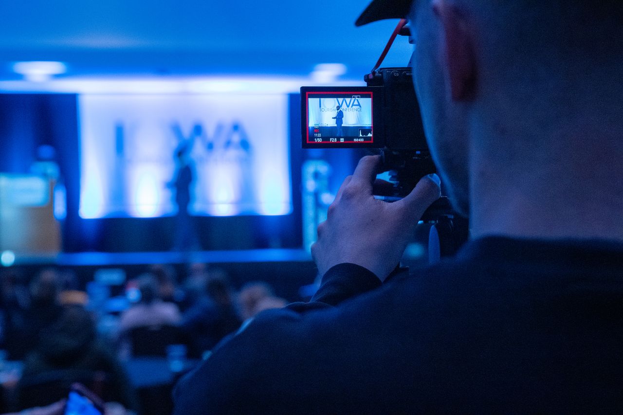 Recording a conference event with an emphasis on professional videography services.
