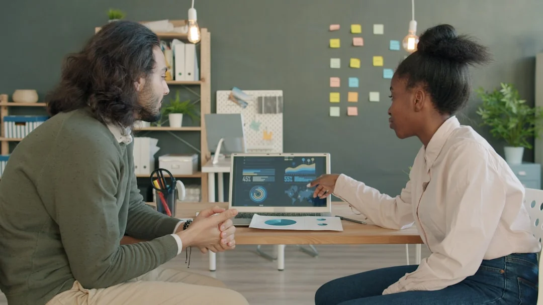 about-01 Man discussing cryptocurrency economics with ring light and laptop, engaging content creation.